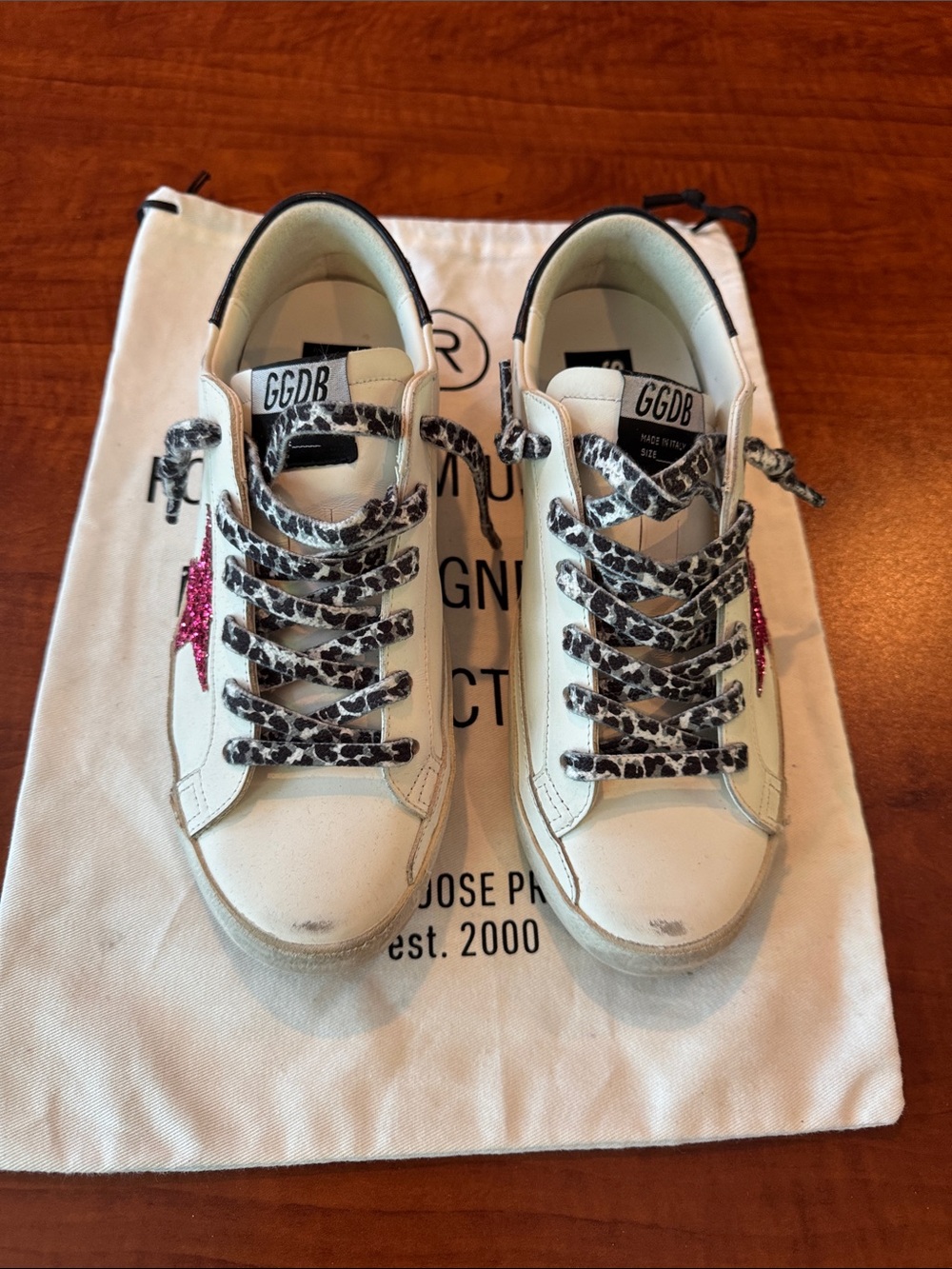 Golden Goose White Leather Sneakers with Black Heel and Leopard Laces.